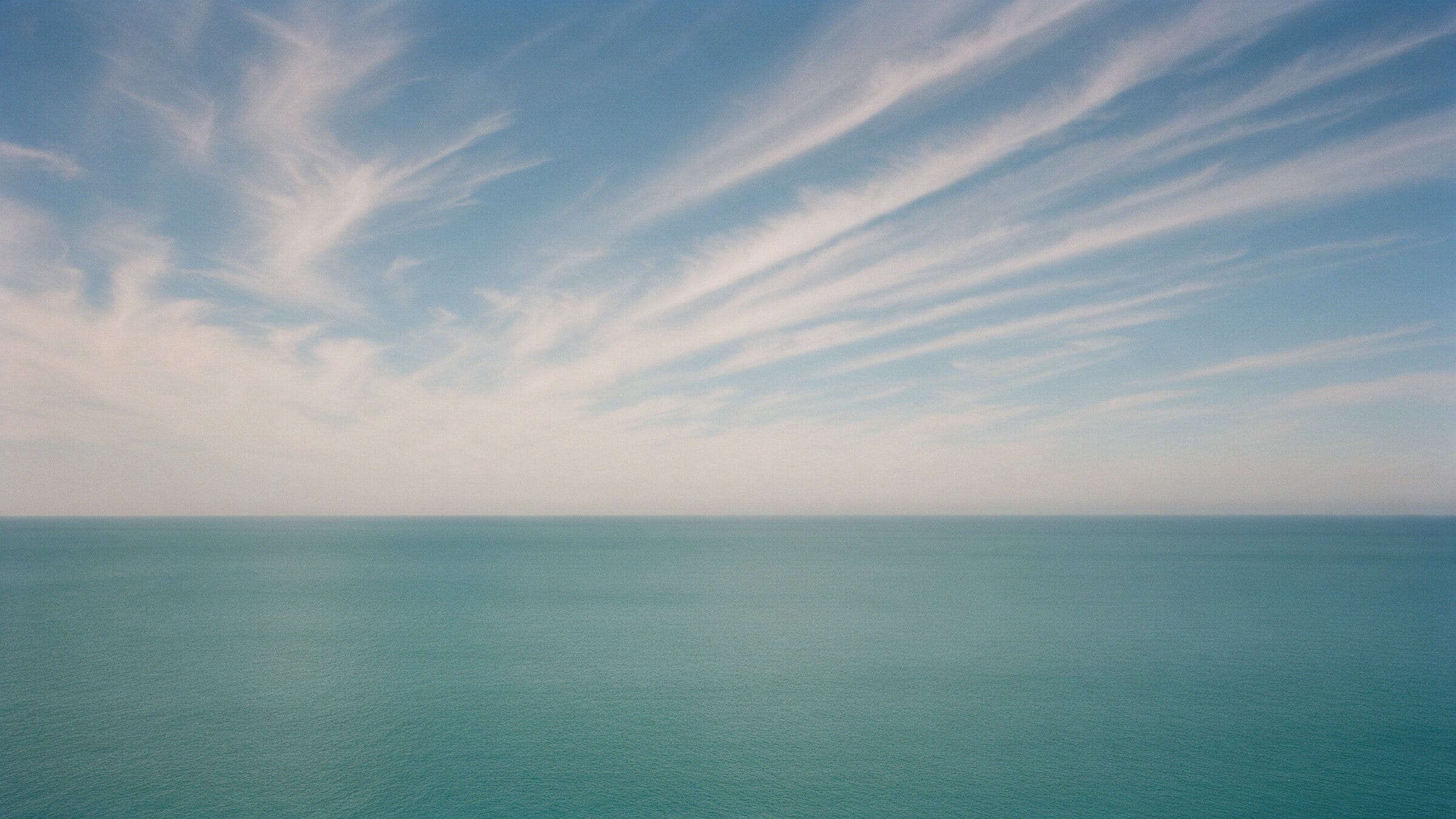 Open Adriatic sea under a summer sky with long feathery clouds